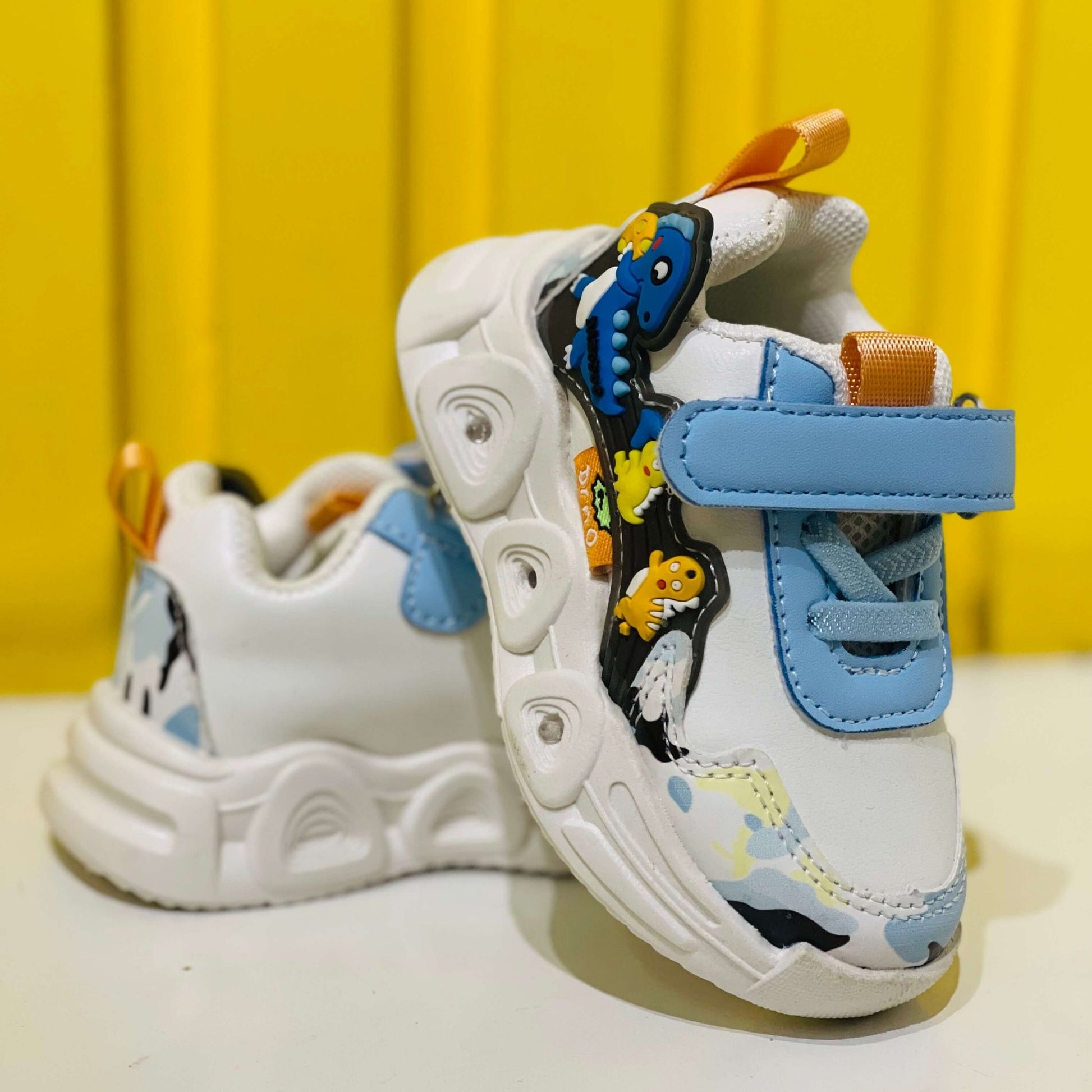 Children's sneakers with cartoon design on a yellow background