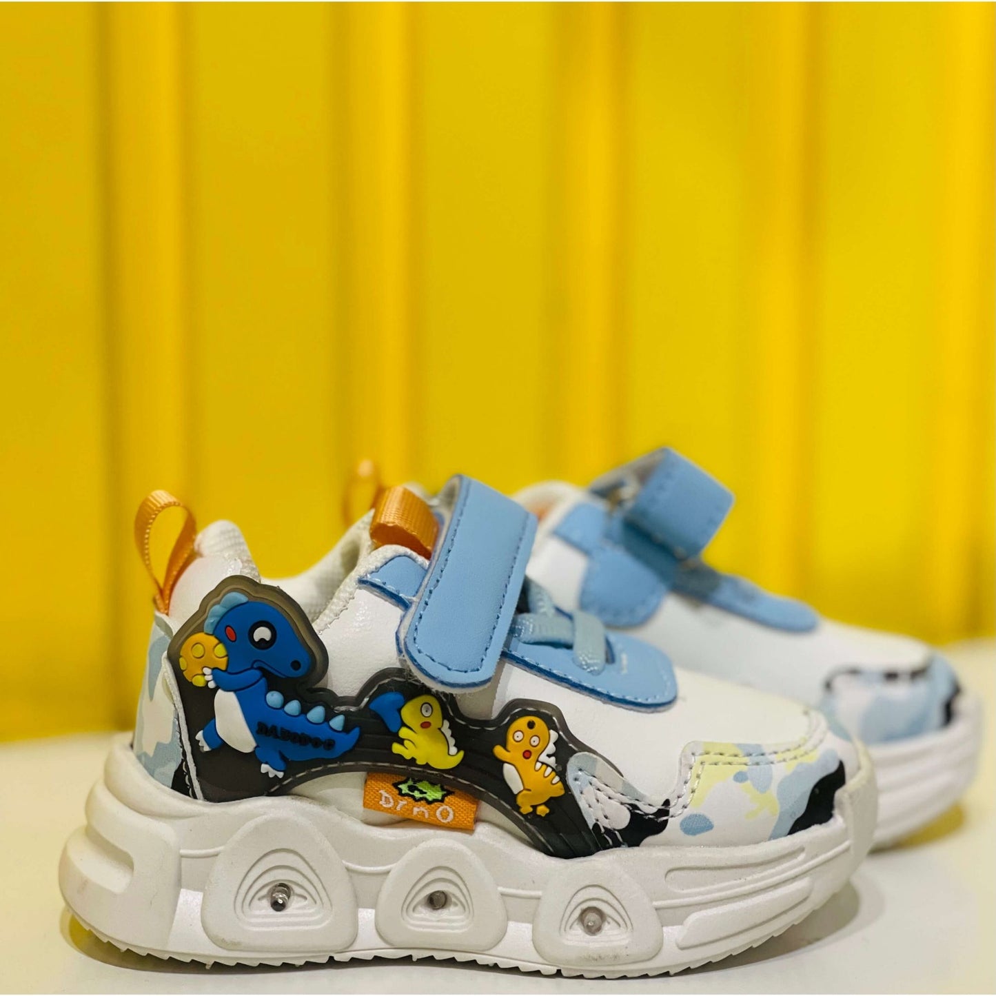 Children's sneakers with cartoon characters on a yellow background