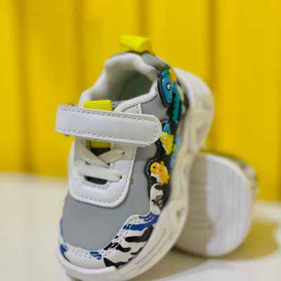 Gray children's shoe with colorful designs on a yellow background