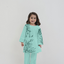 Child wearing a light blue traditional outfit with floral patterns on a white background