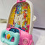 Children's toy car with colorful interior and cartoon character on a white background