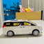 Model of a white van with yellow interior on a surface with a blurred background