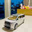 Model toy car on a reflective surface with a blurred background
