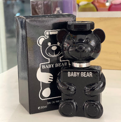 Black bear-shaped perfume bottle with packaging labeled 'Baby Bear' on a white surface.