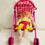 Doll in a pink stroller with a checkered canopy on a light background