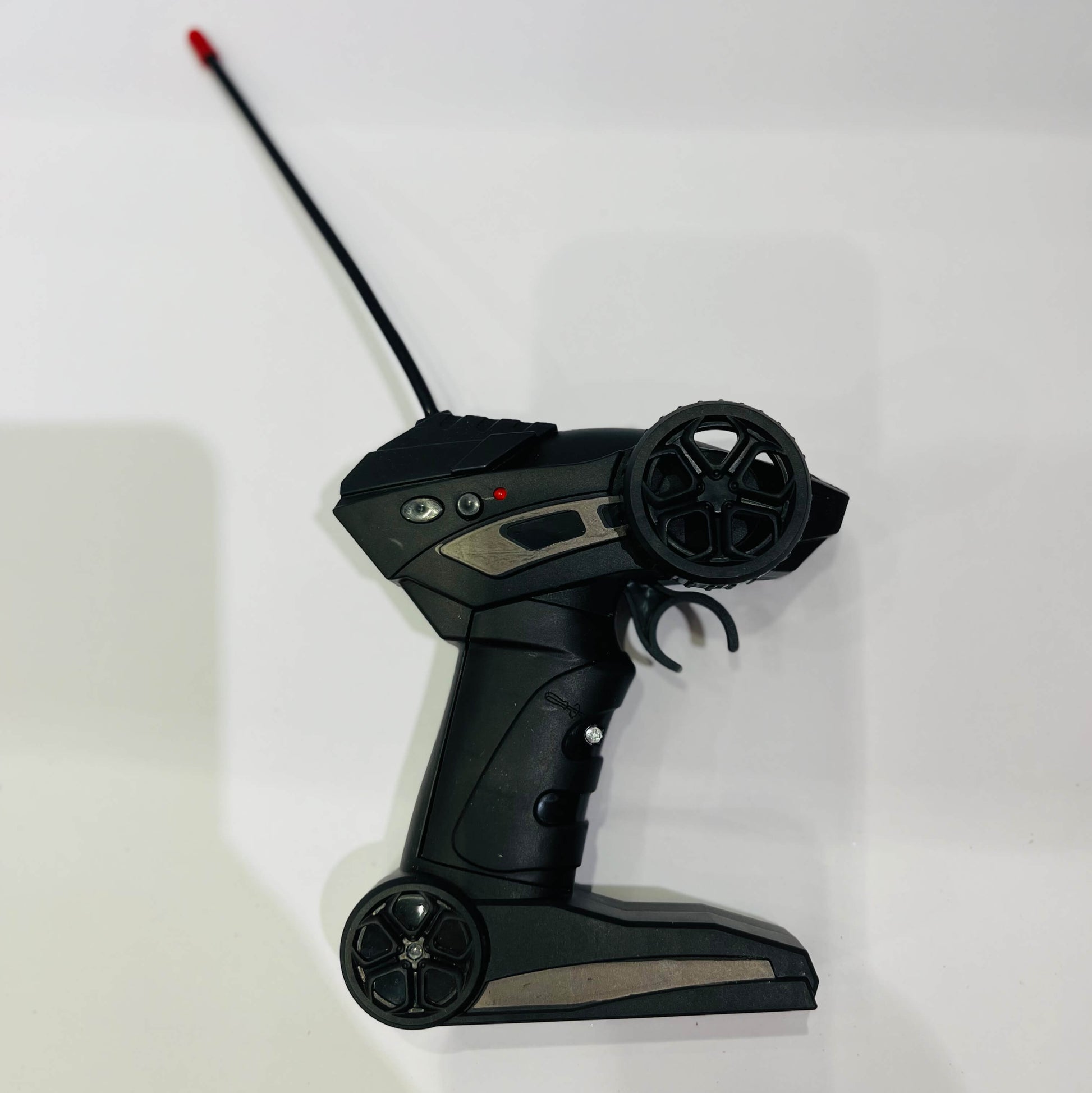 Black remote control with antenna on a white background