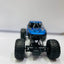 Model of a blue off-road vehicle with large black tires on a white background