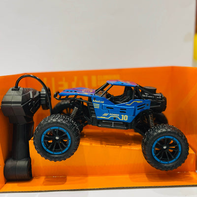 Blue remote control monster truck on an orange stand with a white background