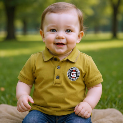 Child wearing a mustard yellow polo shirt with a logo.