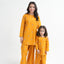 Woman and child wearing matching yellow outfits on a white background