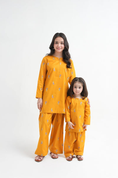 Woman and child wearing matching yellow outfits on a white background