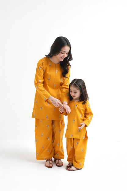 Woman and child in matching yellow outfits on a white background
