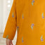 Yellow kurta with floral embroidery on a blurred background
