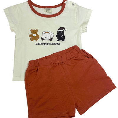 Children's t-shirt with graphic design and red shorts.