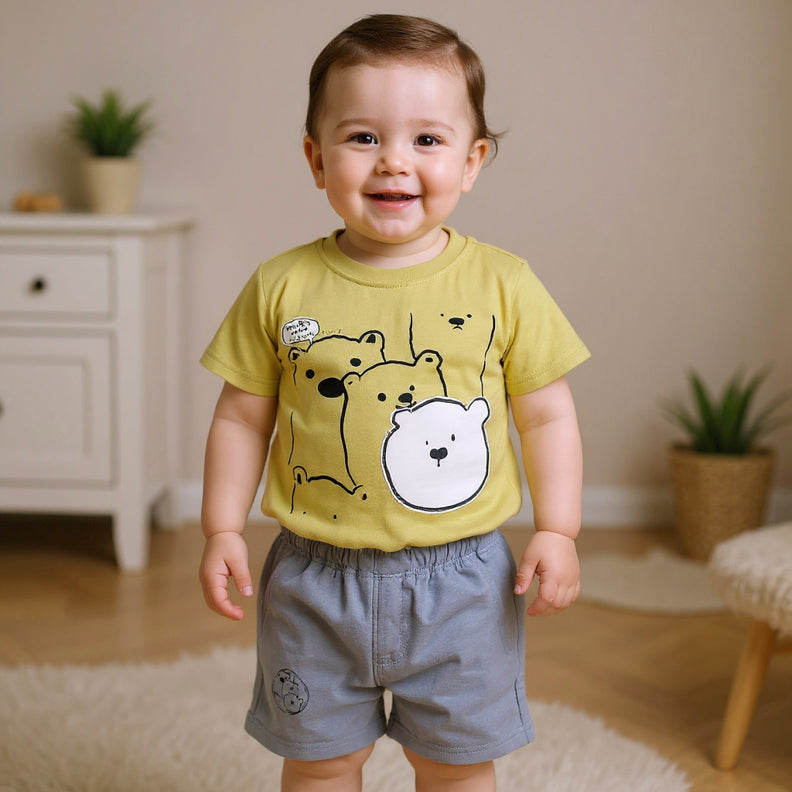Child wearing a yellow t-shirt with bear graphic.