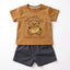 Children's outfit with brown t-shirt and navy shorts featuring a bear graphic and text.