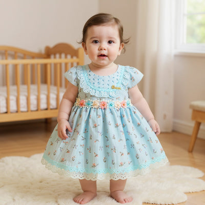 Baby in a light blue floral dress