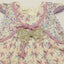 Floral dress with decorative bow.