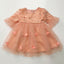 Beige dress with floral embroidery and heart-shaped embellishments