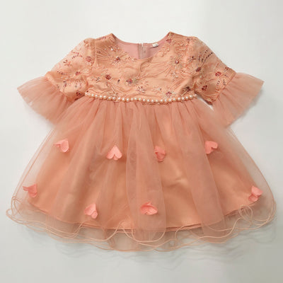 Beige dress with floral embroidery and heart-shaped embellishments