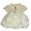White baby dress with floral details and red buttons on a white background