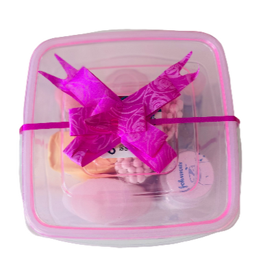 Pink dragon toy in a clear container with pink trim on a white background