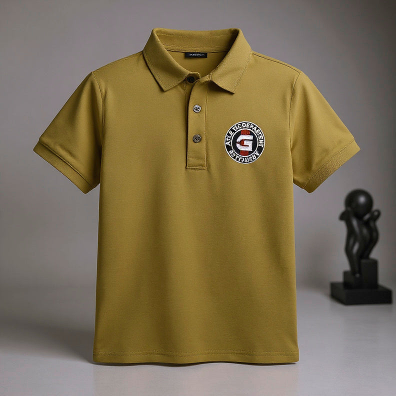 Green polo shirt with a logo on a gray.
