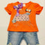 Orange shirt with decorative elements and blue jeans.