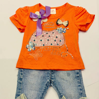 Orange shirt with decorative elements and blue jeans.