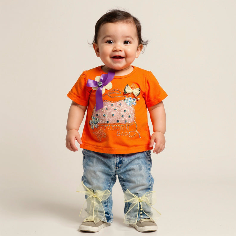 Child wearing an orange shirt with a bow and blue jeans 