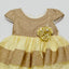 Gold and yellow dress with a floral embellishment 