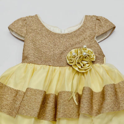 Gold and yellow dress with a floral embellishment 