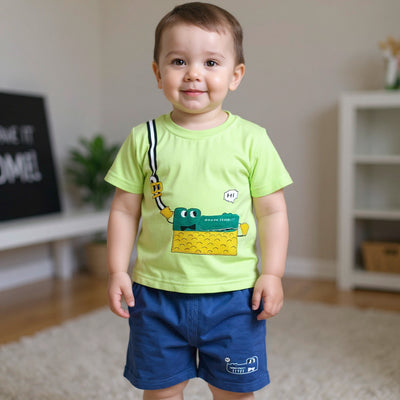 Child wearing a bright yellow shirt with a graphic design and blue shorts.